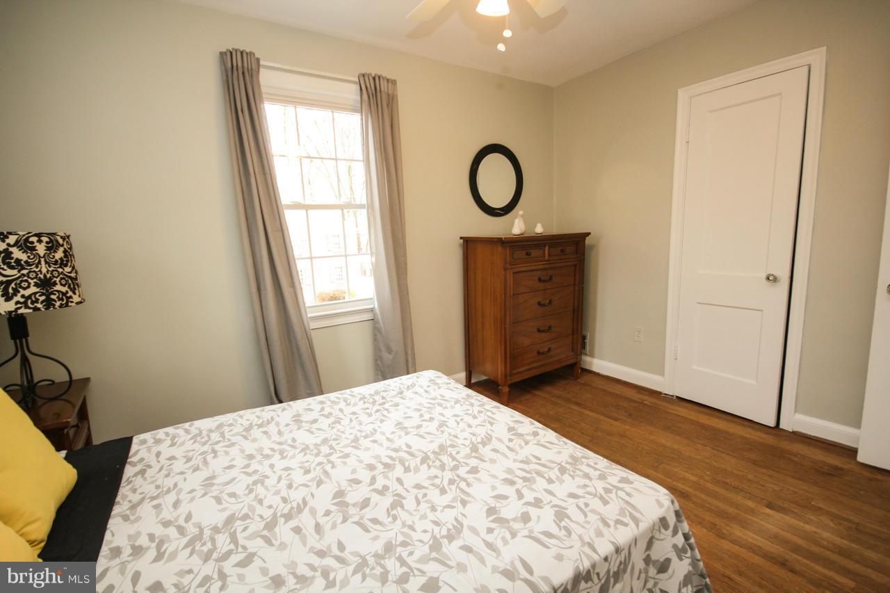 9110 Eton Road Silver Spring, MD 20901 - Photo 22 of 30 a bedroom with a bed and a window