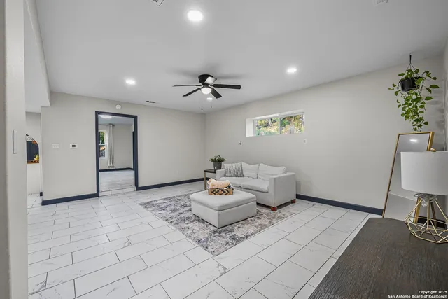 a living room with furniture and flowers