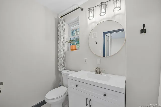a bathroom with a glass shower door