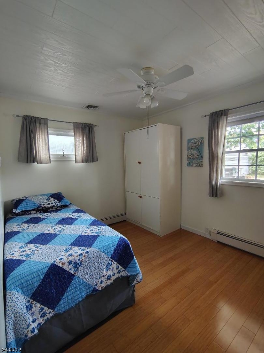 442 River Road North Arlington, NJ 07031 - Photo 9 of 26 a bedroom with a bed closet and window