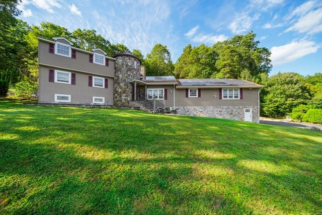 a front view of house with yard and green space
