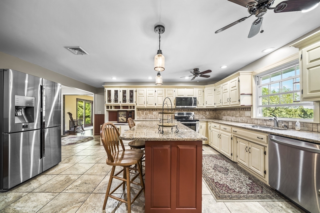 235 James Street Ludlow, MA 01056 - Photo 15 of 41 a kitchen with stainless steel appliances granite countertop a sink stove and refrigerator