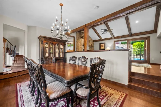 a dining room with furniture a chandelier and wooden floor