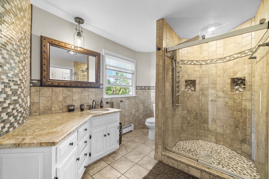 235 James Street Ludlow, MA 01056 - Photo 18 of 41 a bathroom with a granite countertop sink mirror vanity and toilet