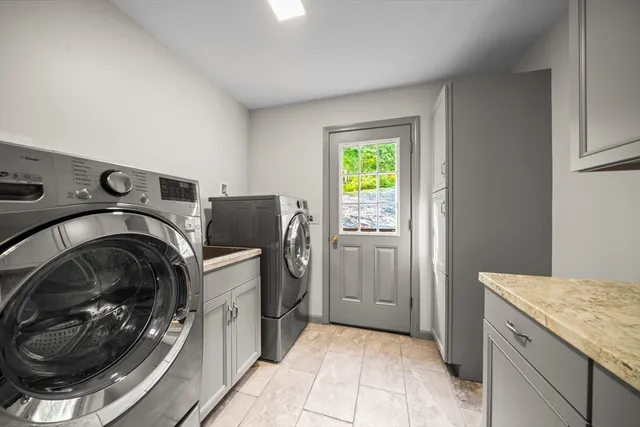 a utility room with sink dryer and washer