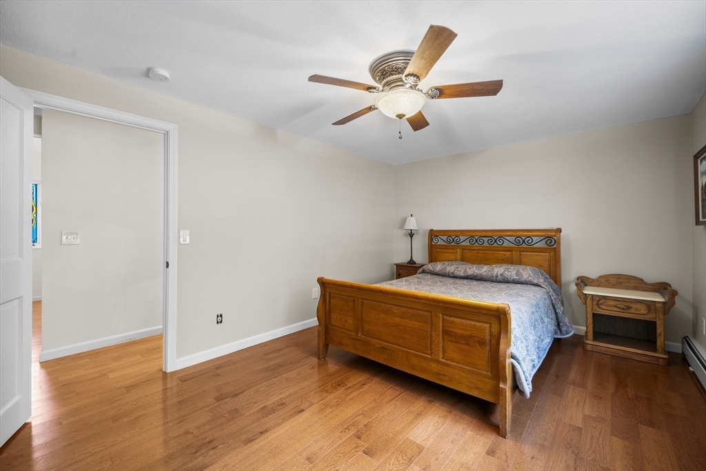 235 James Street Ludlow, MA 01056 - Photo 22 of 41 a bedroom with a bed and a chandelier