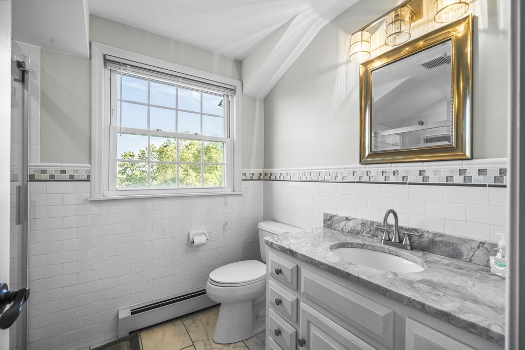 235 James Street Ludlow, MA 01056 - Photo 24 of 41 a bathroom with a granite countertop toilet a sink and mirror