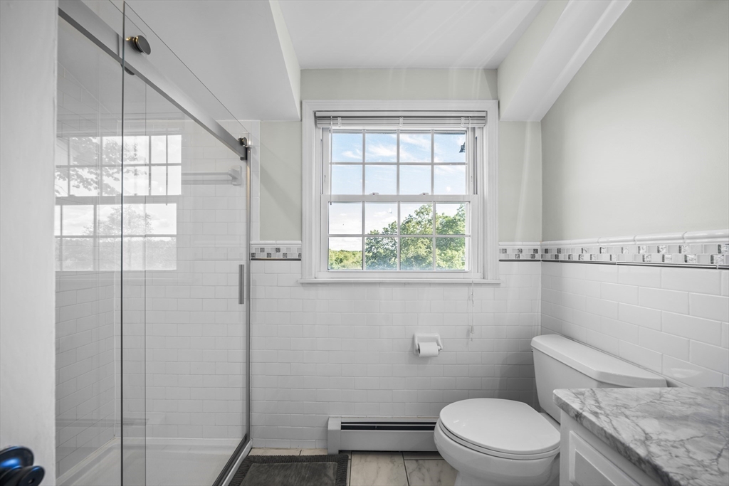 235 James Street Ludlow, MA 01056 - Photo 25 of 41 a white toilet sitting next to a window in a bathroom
