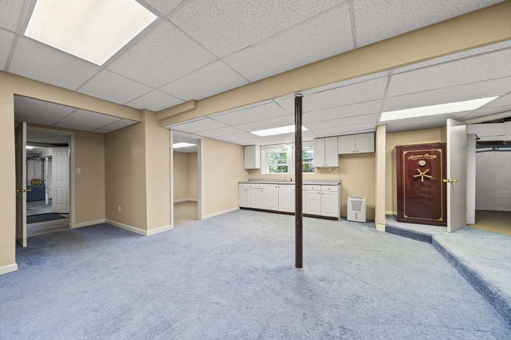 235 James Street Ludlow, MA 01056 - Photo 27 of 41 an empty room with white cabinet and mirrors