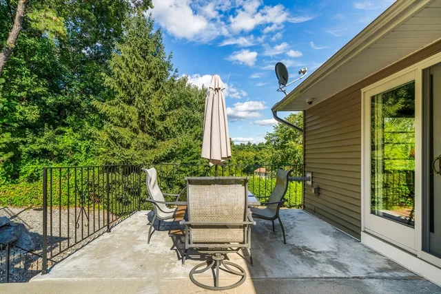 a view of a patio with a table and chairs and potted plants