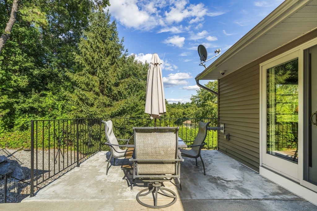 235 James Street Ludlow, MA 01056 - Photo 29 of 41 a view of a patio with a table and chairs and potted plants