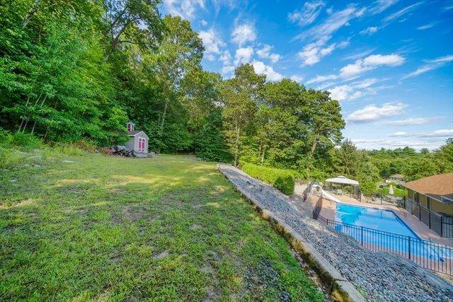 a view of a garden with a bench in the garden