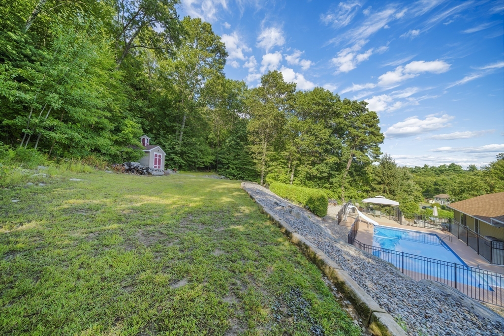 235 James Street Ludlow, MA 01056 - Photo 37 of 41 a view of a garden with a bench in the garden