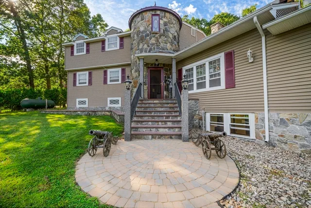 a view of a house with a yard chairs and plants