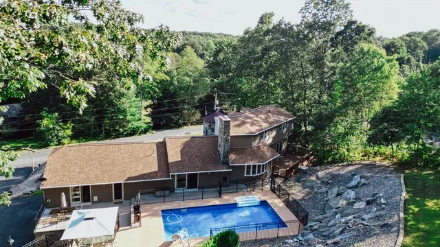 a view of house with roof deck and seating space