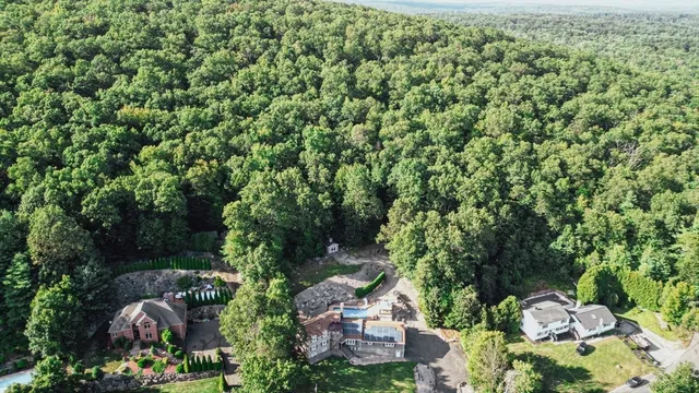 an aerial view of a house with a yard