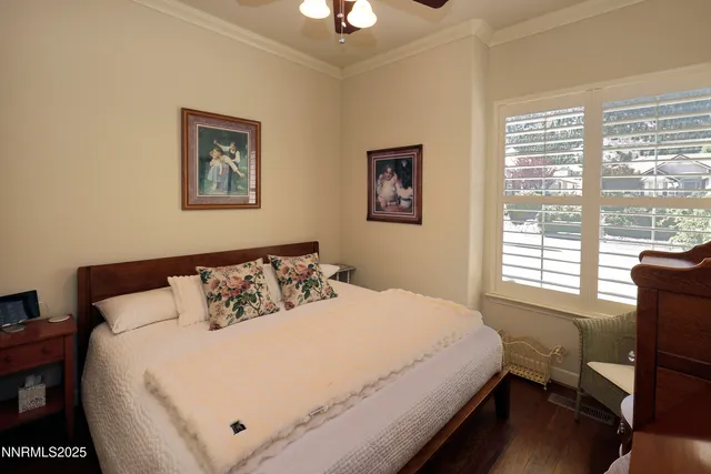 a large bed sitting in a bedroom next to a window