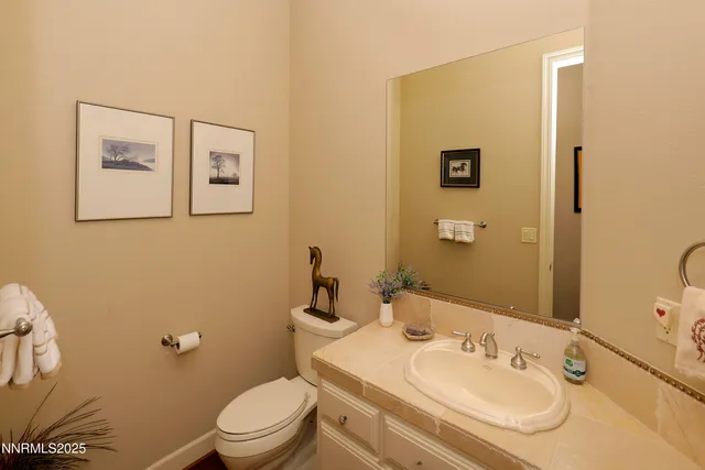 a bathroom with a sink a toilet and mirror