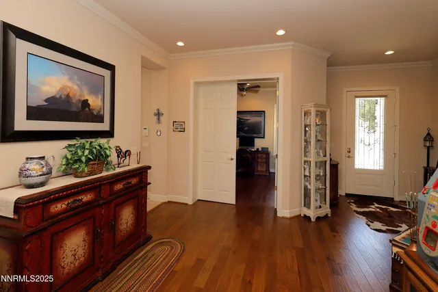 a view of a hallway with wooden floor and furniture