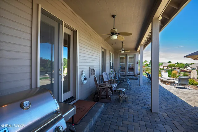 a view of a porch with chairs and potted plants