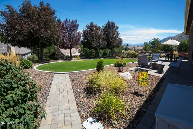 a view of patio with table and chairs under an umbrella