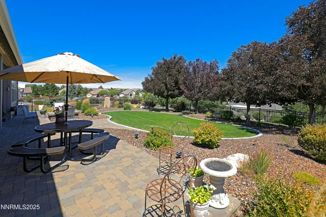 a front view of a house with garden and sitting area