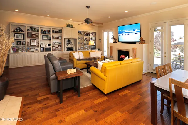a living room with fireplace furniture and a flat screen tv