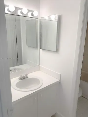 a bathroom with a sink and mirror