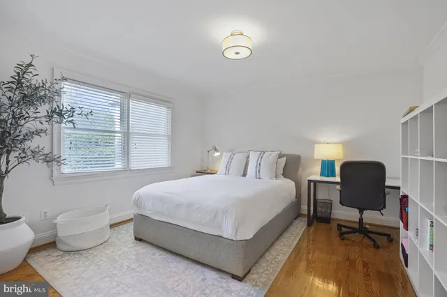 a bedroom with a bed and a chair