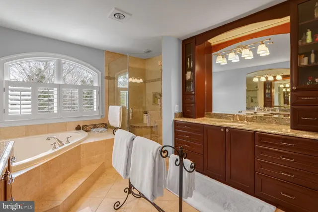 a spacious bathroom with a large tub and sink