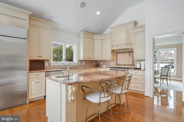 a kitchen with stainless steel appliances granite countertop a stove top oven a sink a counter space and cabinets