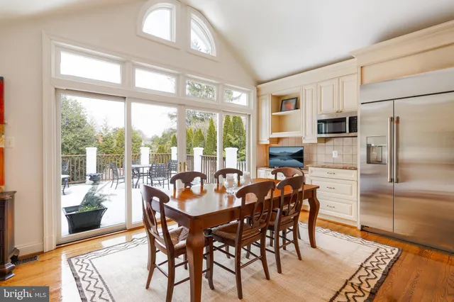a dining room with furniture a chandelier and wooden floor