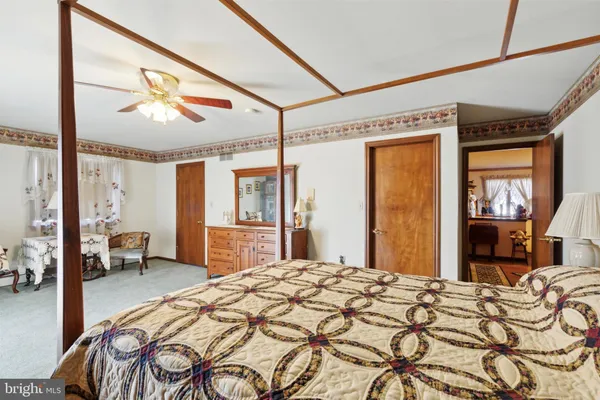 a bedroom with a large bed and a chandelier