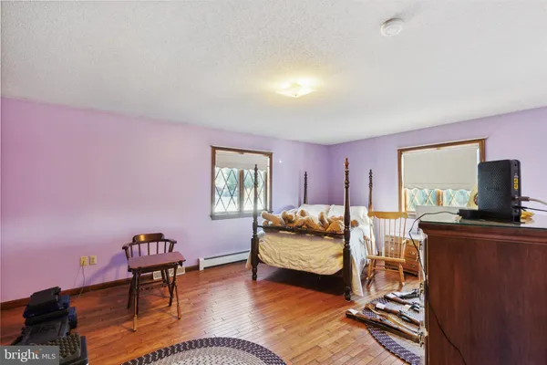 a bedroom with a bed and a mirror