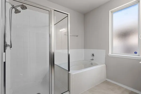 a bathroom with a bathtub and a shower