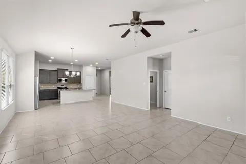 a view of a kitchen with furniture and a ceiling fan