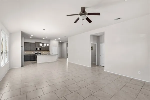 a view of a kitchen with furniture and a ceiling fan