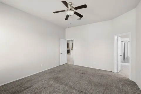 a view of a big room with chandelier fan