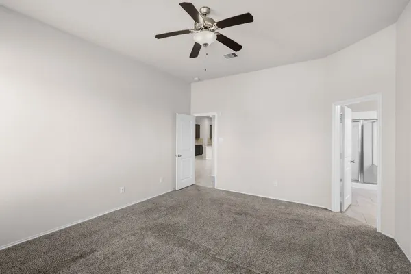 a view of a big room with chandelier fan