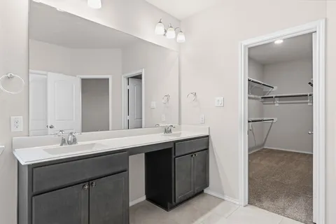 a bathroom with a double vanity sink mirror and double