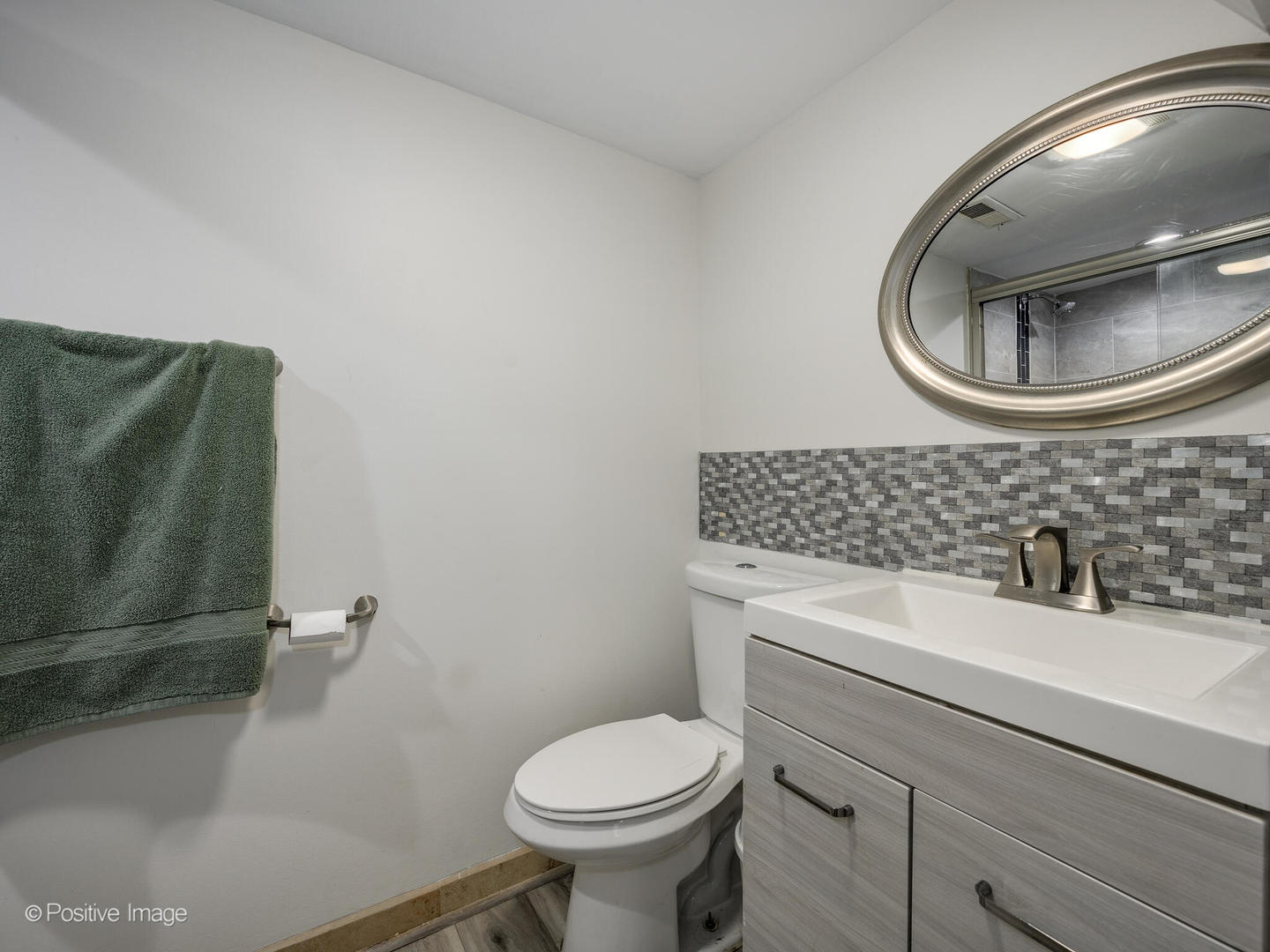 3742 Clinton Avenue Berwyn, IL 60402 - Photo 23 of 28 a bathroom with a sink and a mirror