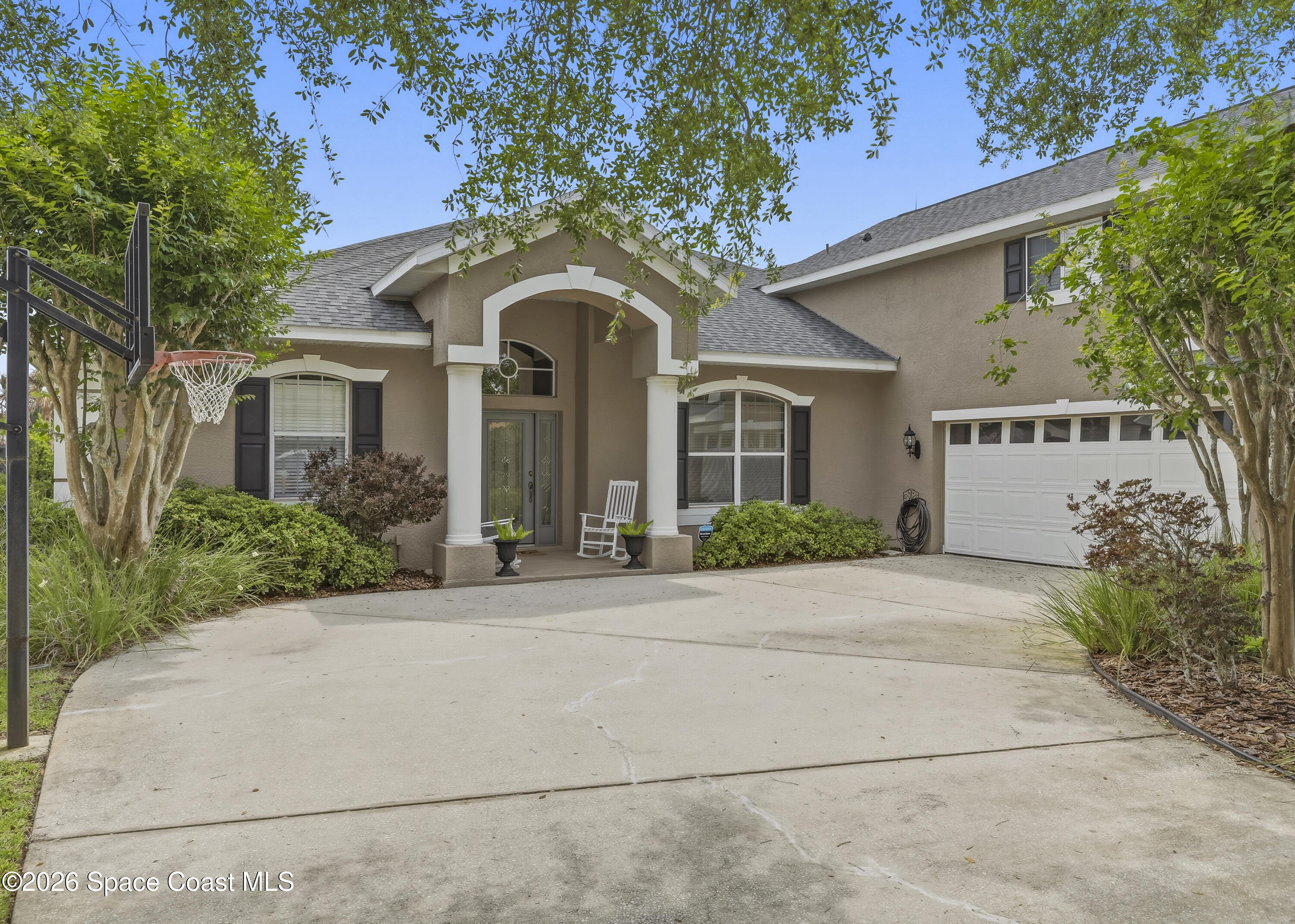 1643 Long Pine Road Melbourne, FL 32940 - Photo 3 of 63 a front view of a house with yard and tress