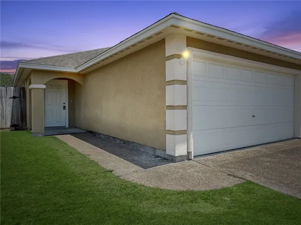 a backyard of a house with lots of green space and wooden fence