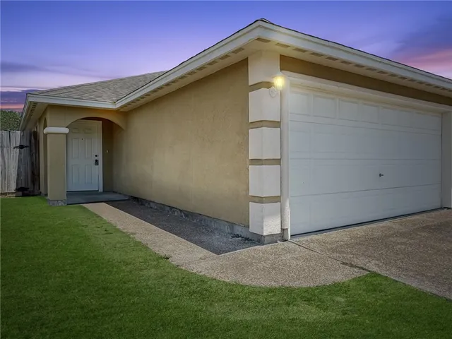 a backyard of a house with lots of green space and wooden fence