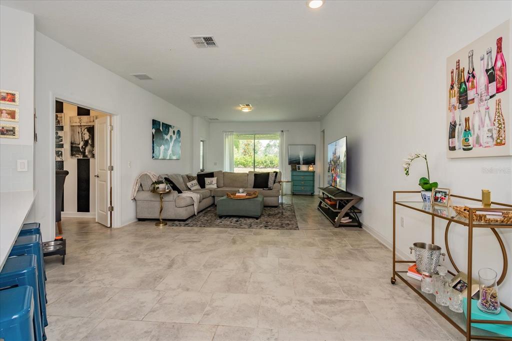 5616 Quiet Palm Loop St. Cloud, FL 34771 - Photo 12 of 25 a living room with furniture and a flat screen tv