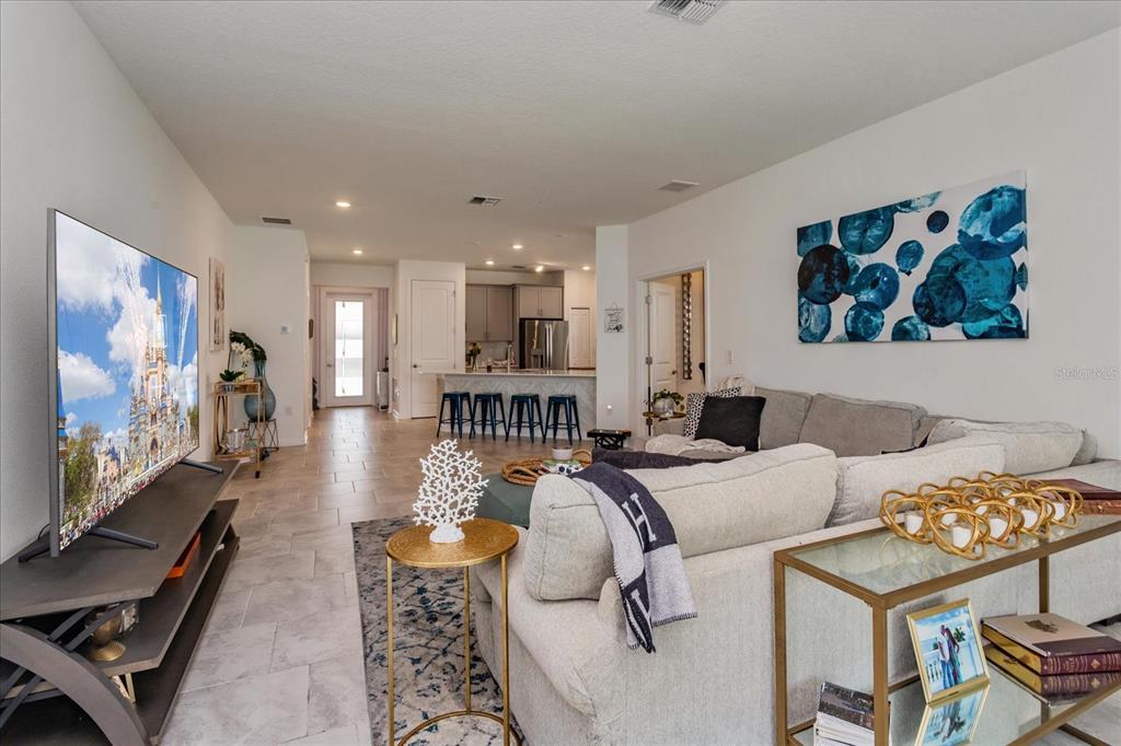 5616 Quiet Palm Loop St. Cloud, FL 34771 - Photo 13 of 25 a living room with furniture and a flat screen tv