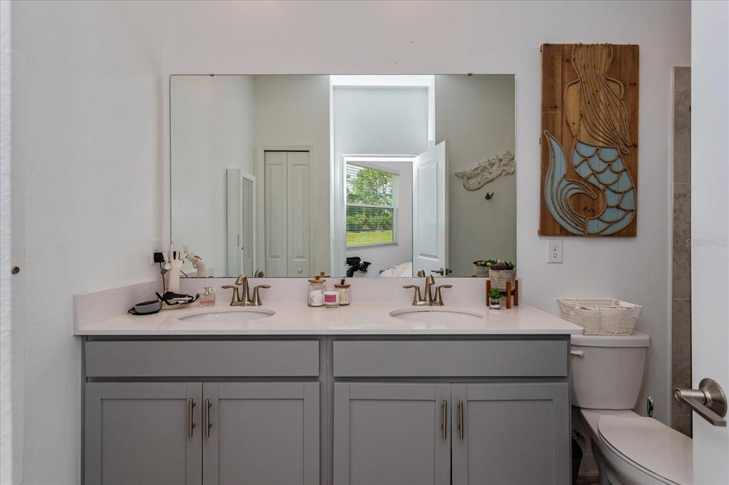 5616 Quiet Palm Loop St. Cloud, FL 34771 - Photo 15 of 25 a bathroom with a sink and a toilet