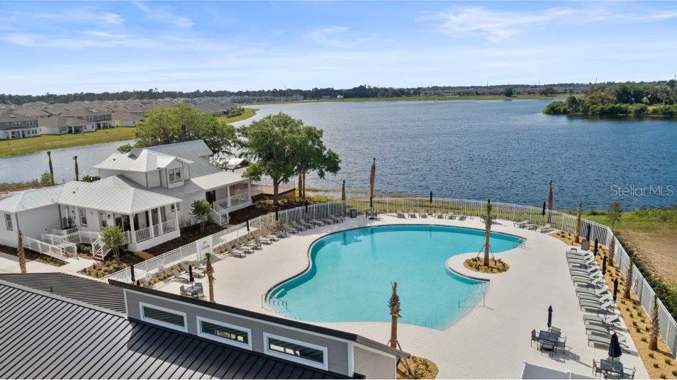 5616 Quiet Palm Loop St. Cloud, FL 34771 - Photo 2 of 25 a view of a lake with couches and city view