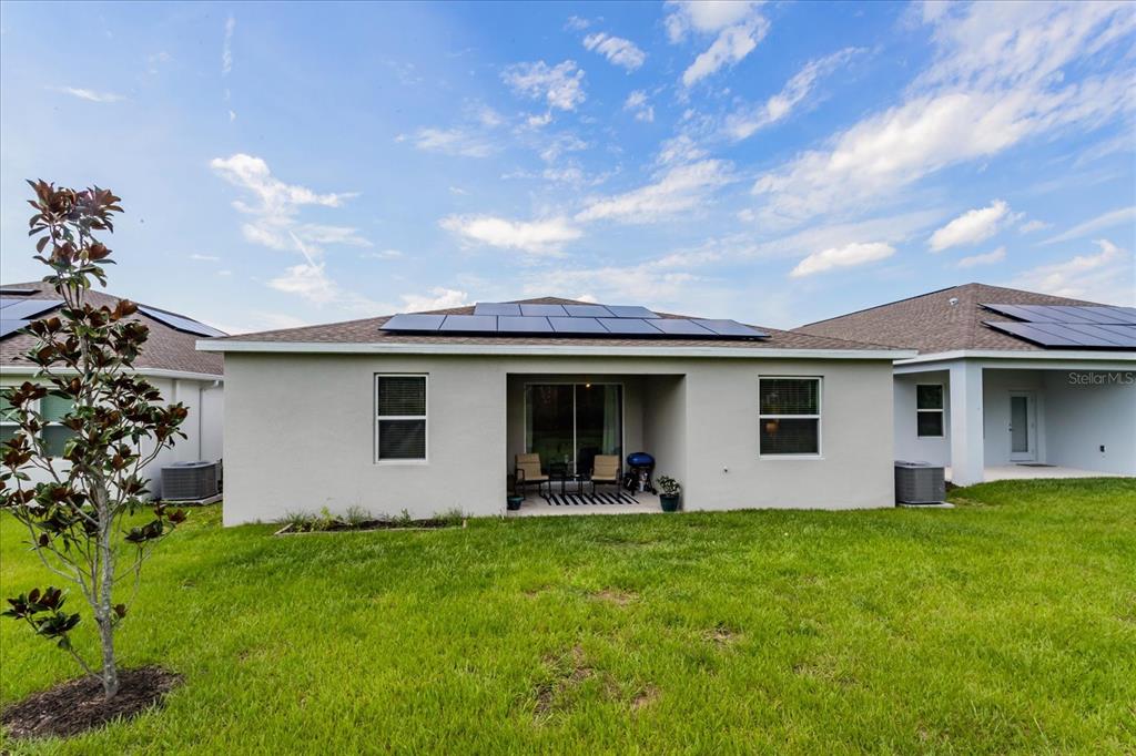 5616 Quiet Palm Loop St. Cloud, FL 34771 - Photo 25 of 25 a view of a house with backyard and garden