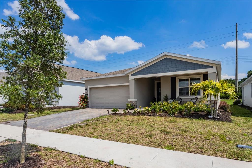 5616 Quiet Palm Loop St. Cloud, FL 34771 - Photo 3 of 25 a front view of a house with garden